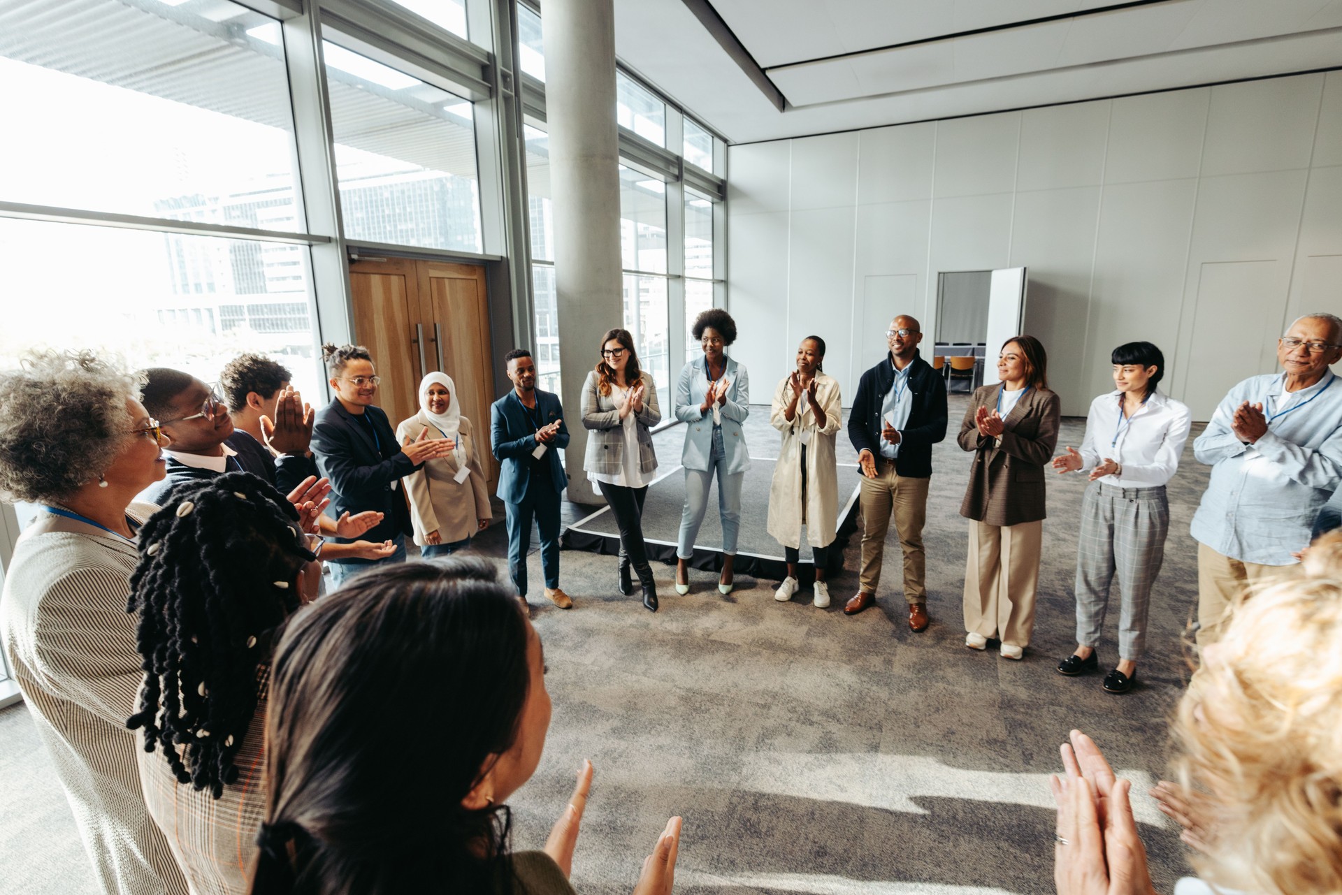 Diverse team in a circle participating in a teambuilding exercise in a modern office space